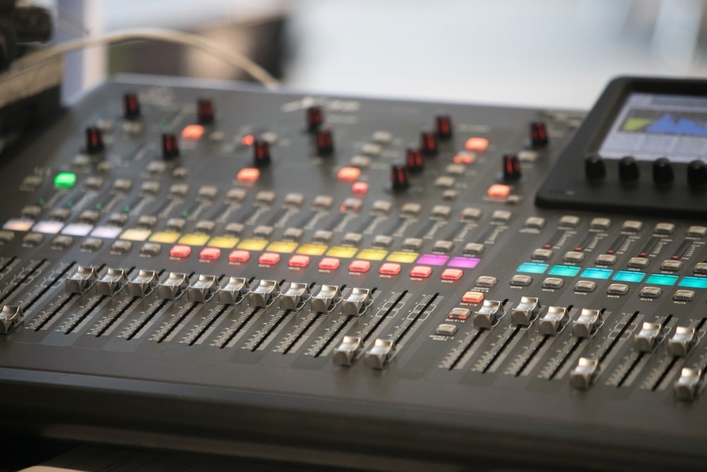 The audio equipment, control panel of digital studio mixer, side view. Close-up, selected focus